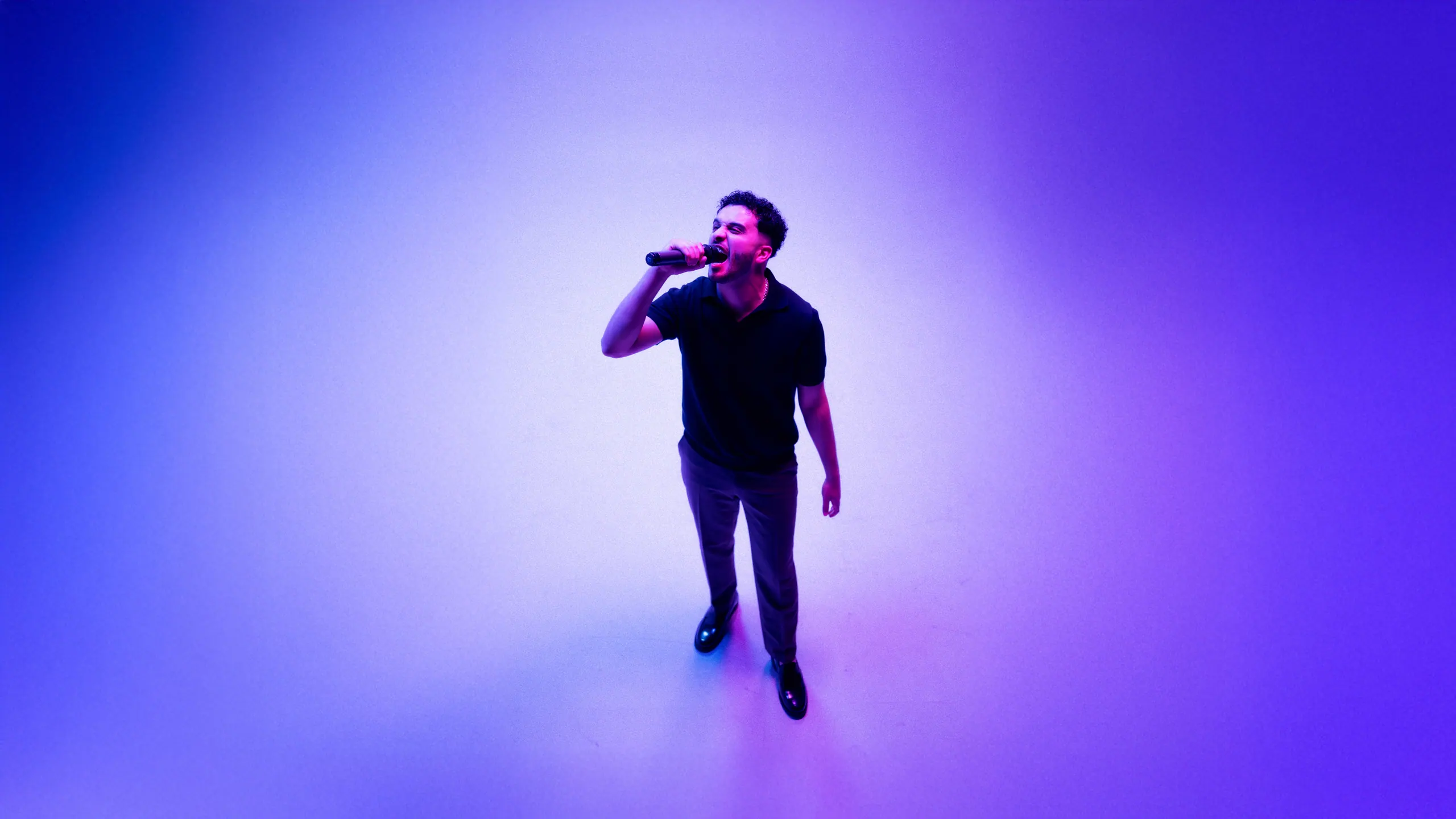 Hamoodi performing with a microphone